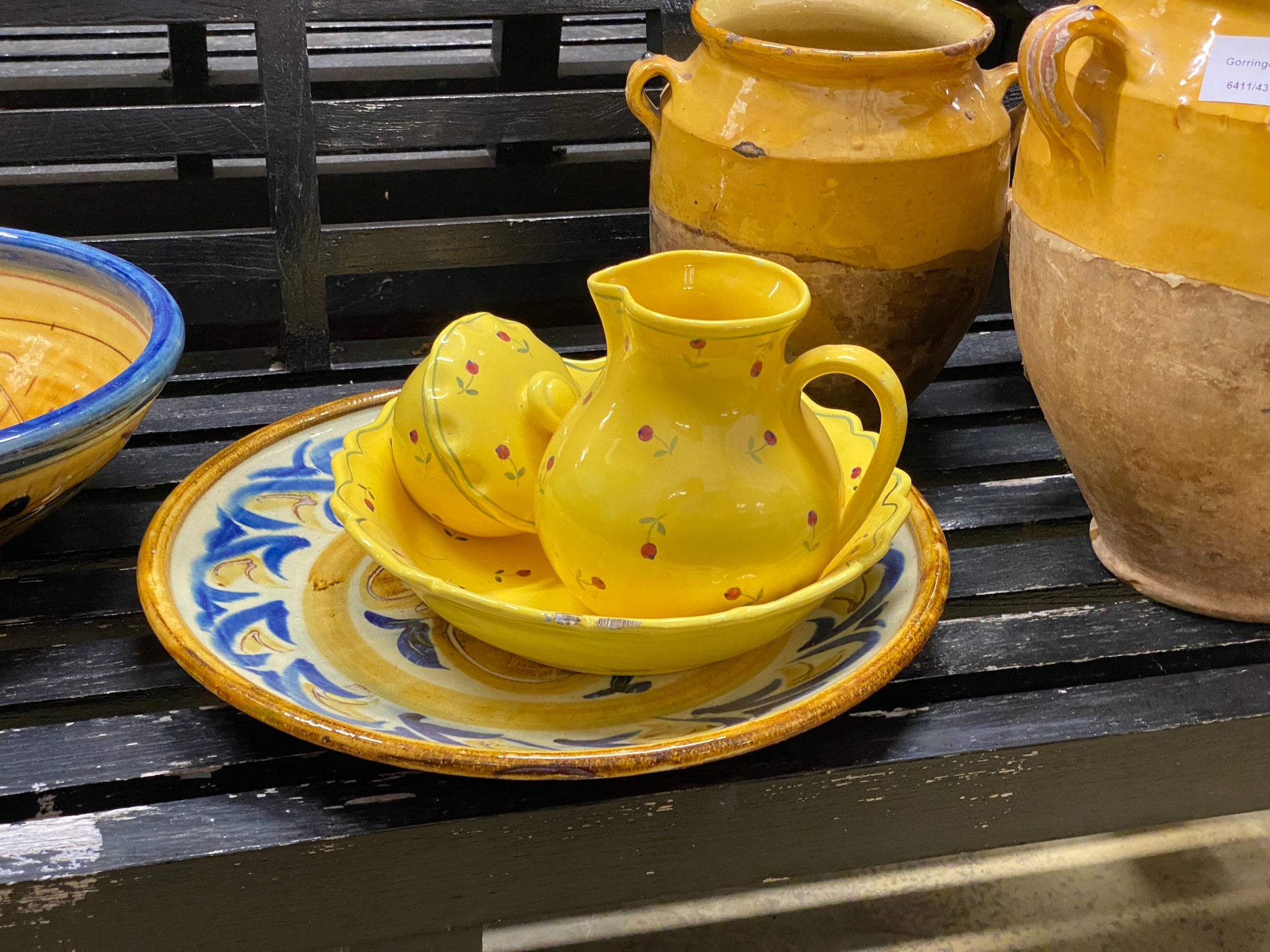 Twelve pieces of Continental glazed earthenware, largest 34cm, a bamboo vase, etc.